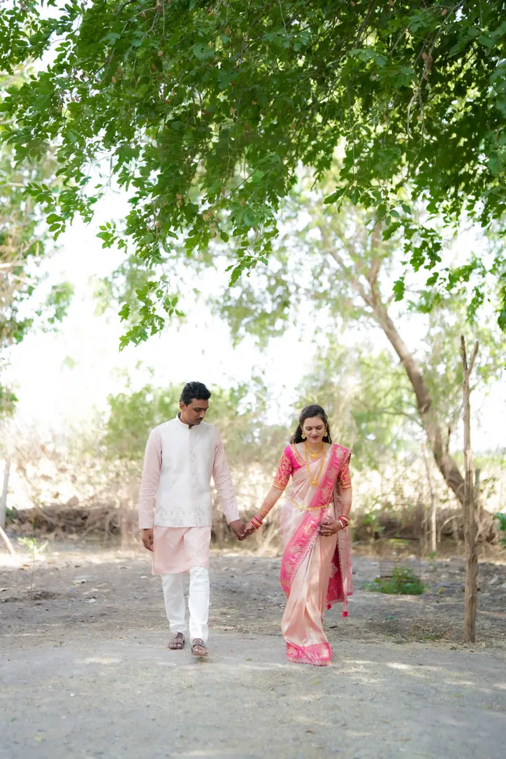 Darshan and Harshali walking together under the trees